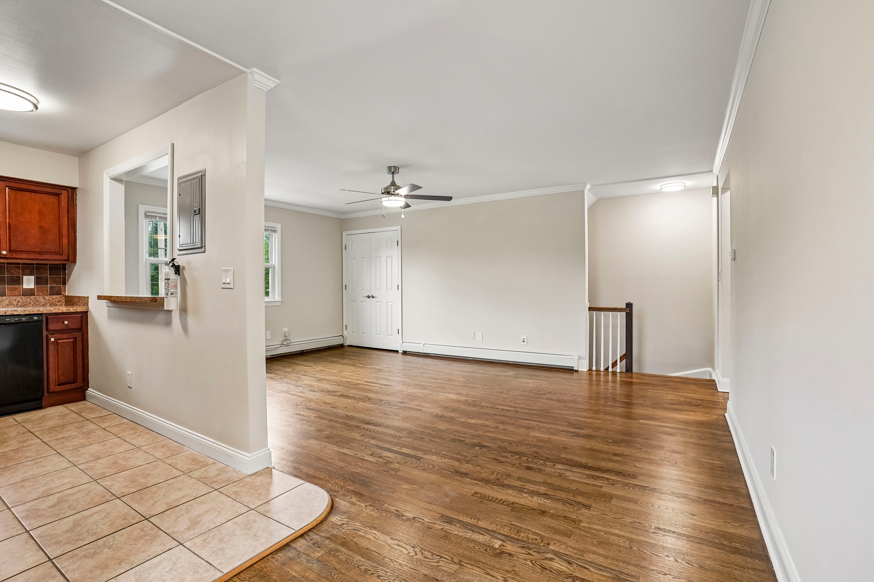 A room with wooden floors and a ceiling fan.
